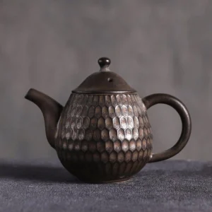 full side view of 3.4oz handcrafted textured dark brown porcelain teapot
