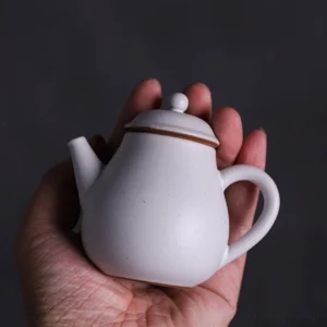 full view 3oz small white porcelain teapot with brown accent built in filter