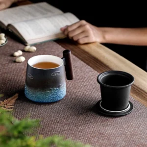 Black blue gradient ceramic tea infuser mug with lid and wooden handle overall view