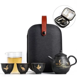Complete black ceramic travel chawan set with golden crane pattern and black carrying bag