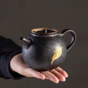 Black gold porcelain teapot with golden leaf insect decoration main view