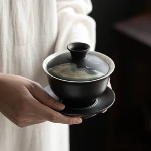 Black porcelain gaiwan with mountain bird ink wash pattern full view