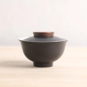 Full view of black textured 5oz porcelain gaiwan with wood lid knob
