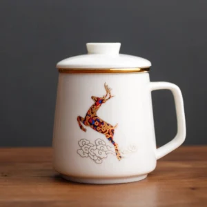 full product view of white ceramic tea infuser mug with gold trim and lid