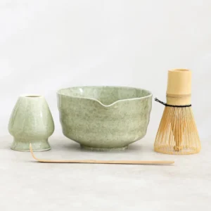 Complete 4-piece sage green ceramic matcha chawan bowl set with bamboo whisk, scoop and whisk holder
