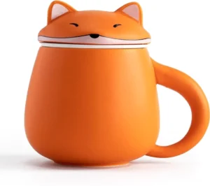 Full side view of cute orange fox ceramic tea infuser mug with lid showing fox tail handle