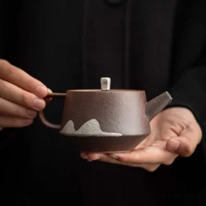Handcrafted 6oz faraway mountain porcelain teapot full product view with deep brown body and white mountain pattern