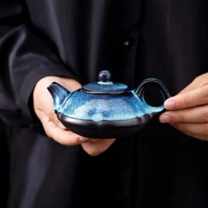 front view of handcrafted blue black Jian Zhan porcelain teapot with hare's fur glaze