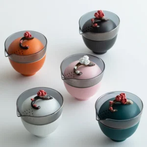 Full assembled portable ceramic travel chawan set with plum blossom lid next to protective carry bag