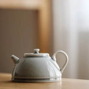 Full view of handcrafted muted gray celadon style porcelain teapot 7oz