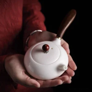 Full view of 6.4oz white porcelain Japanese Kyusu teapot with dark brown wooden side handle