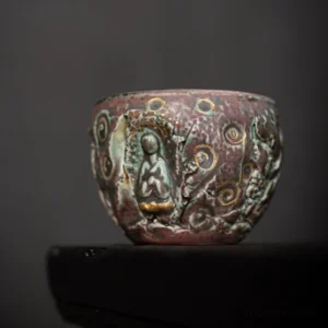 Hand carved Buddha Chinese ceramic tea cup side view with gold detailing