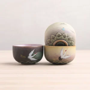 Collection of hand-painted Chinese ceramic crane lotus tea bowls with traditional patterns