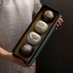 Full set of hand-painted gold lotus ceramic Chinese tea cups showing 4 assorted matte colors