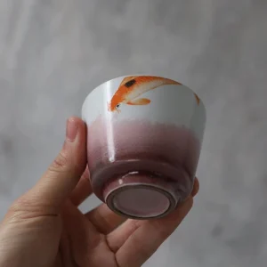 collection of hand-painted koi porcelain tea cups in four styles