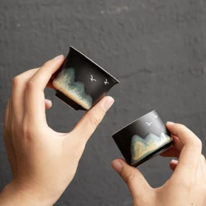 Hand painted mountain and bird Chinese ceramic tea cup on wooden tea tray