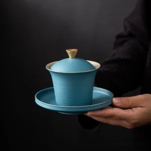 Handcrafted 6oz porcelain gaiwan with gold accents blue variant front view