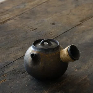Full view of handcrafted gilded ceramic kyusu teapot with hemp wrapped side handle