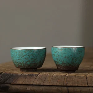 Handcrafted green textured ceramic Chinese tea cup with brown patterning