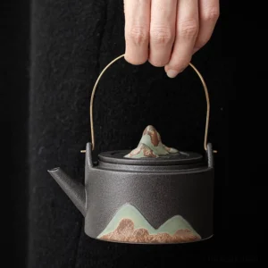 Handcrafted mountain design porcelain teapot with brass handle full view