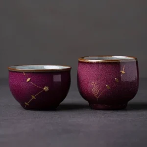 Handcrafted purple red Chinese ceramic tea cup with gold floral decoration