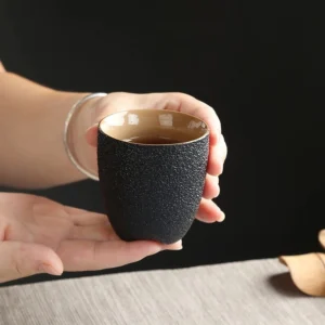 Handcrafted textured black clay ceramic tea cup 5oz side view