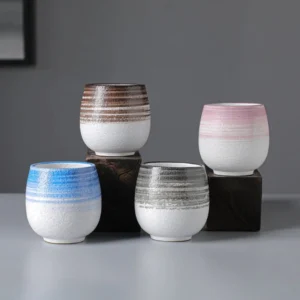 Collection of four textured handcrafted Japanese ceramic tea bowls in different colors