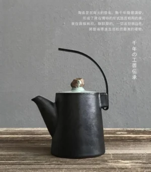 handmade black ceramic teapot with natural stone lid knob and metal handle side view
