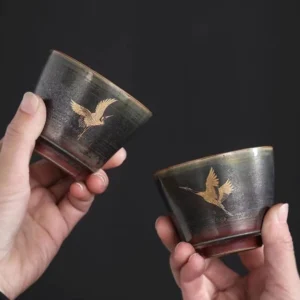 handmade gold crane motif chinese ceramic tea cup side view