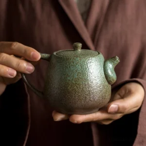 full side view of japanese rustic handcrafted ceramic teapot