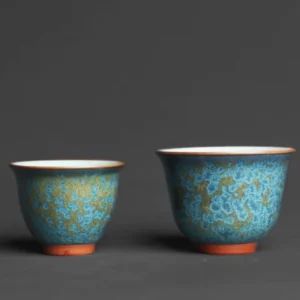 Jianzhan style set of two Chinese ceramic tea cups on wooden tea table