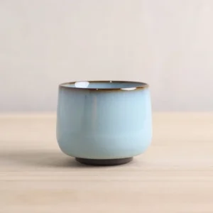 3.4oz light blue Chinese tea cup with ancient copper coin base detail side view