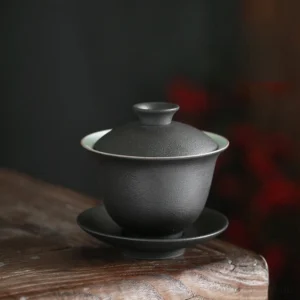 Full view of matte black dual-tone 5oz porcelain gaiwan with lid bowl and saucer