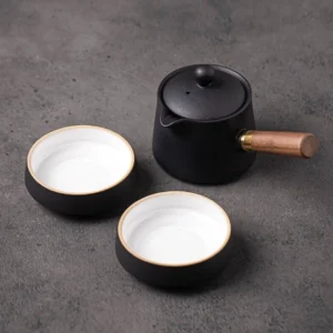 Complete portable black ceramic travel chawan set with detachable wood handle and two stacking teacups