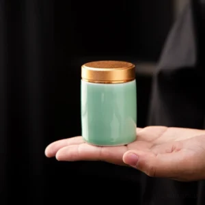Portable light green ceramic matcha powder canister with gold lid side view