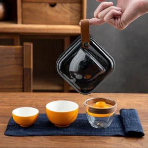 Complete portable chawan travel tea set with glass gaiwan, orange ceramic cups, black travel bag