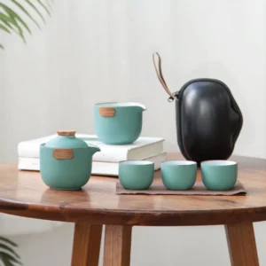 Full portable travel kung fu chawan set with black hard-shell travel case open showing teal ceramic and wood茶具