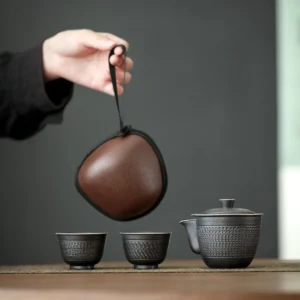 Full display of silver black ceramic portable travel chawan tea set with carrying case
