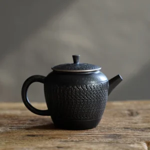 Full side view of textured black porcelain teapot with built in strainer 5.4oz