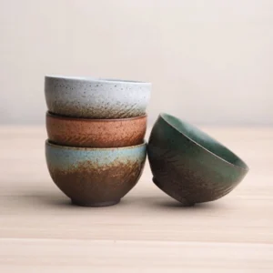 Group display of vintage handcrafted petal-shaped Chinese ceramic tea bowls multiple glaze options