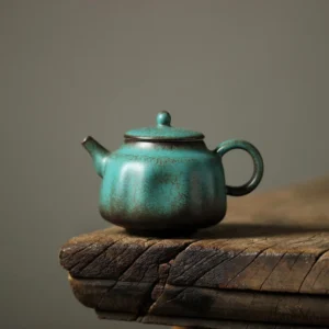 full side view of vintage green speckled porcelain teapot 5oz